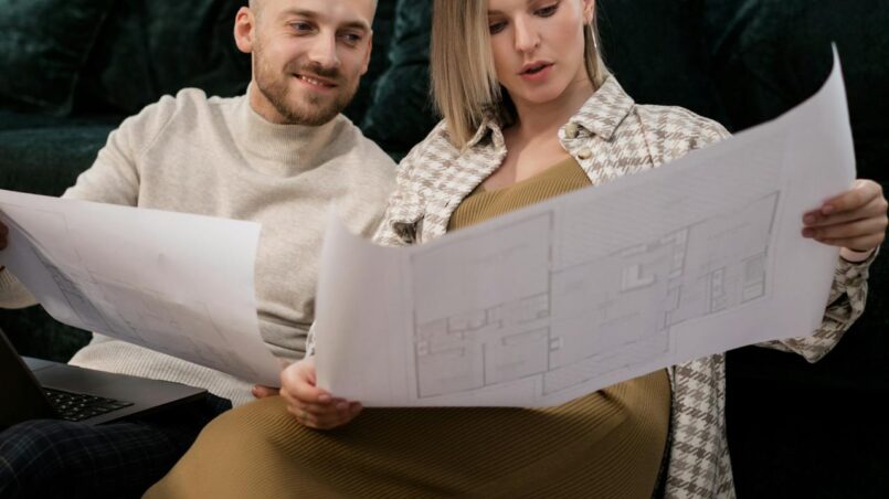 husband and wife looking at renovation plans
